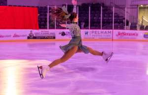 Thumbnail photo of Figure skater jumping on the ice rink in Pelham
