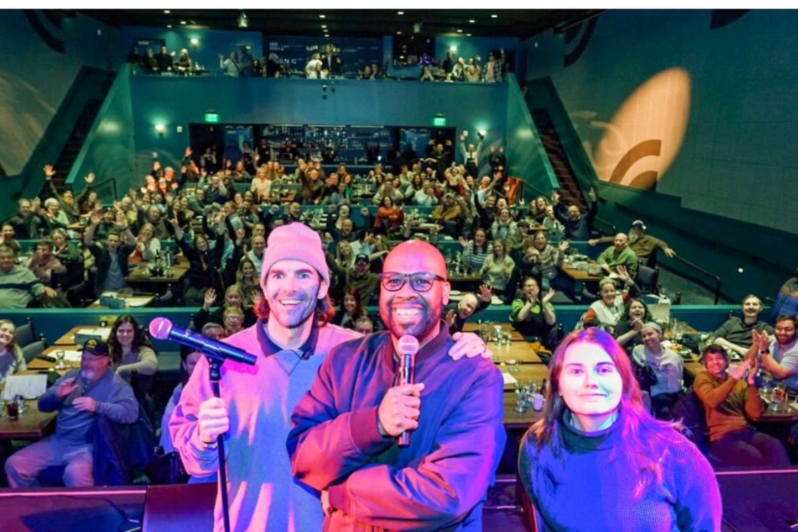 Photo of Comedian Dante and Friends on the stage of the Ingersoll with the audience behind them laughing and waving