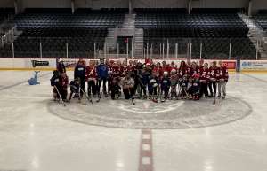 Thumbnail photo of Girls learn hockey program students pose with the Alabama ladies hockey team at Pelham Ice Arena