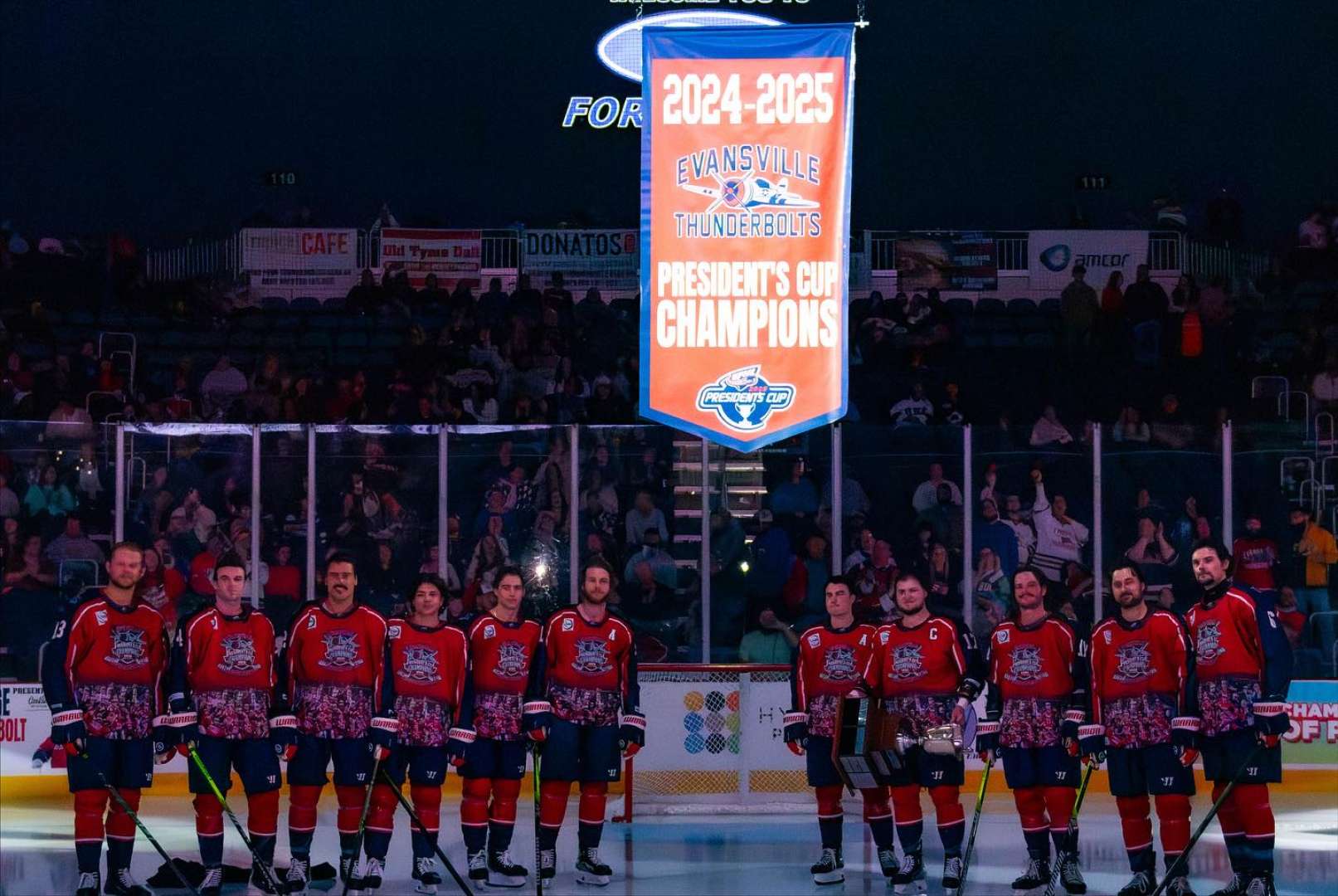 Photo of Evansville Thunderbolts hockey team captured the SPHL Presidents Cup in May 2025,on the ice with the penant