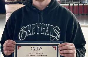 Thumbnail photo of Carson Dalland holding his outstanding frontline employee award from Visit Nebraska