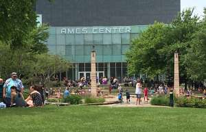 Thumbnail photo of Ames Center Masquerade Theatre exterior with people enjoying the sunshine