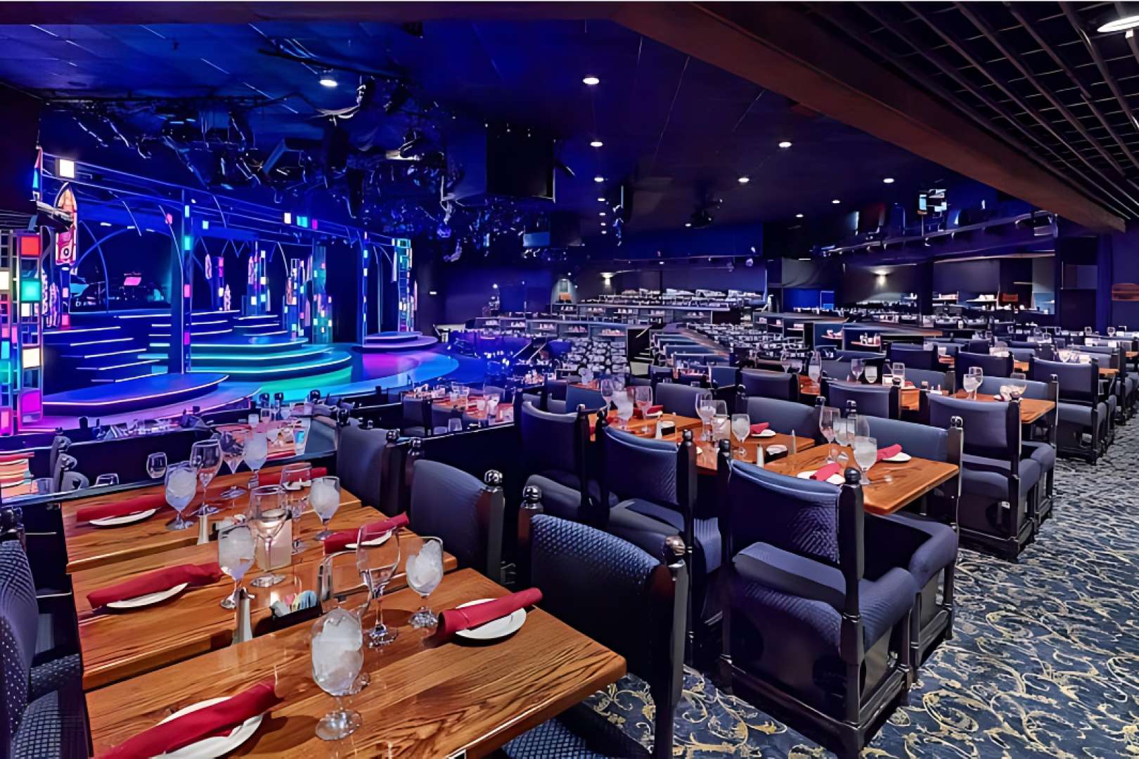 Photo of Dining tables with stage in background at Chanhassen Dinner Theater
