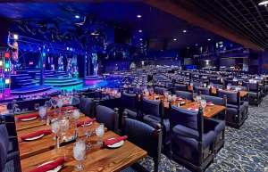 Thumbnail photo of Dining tables with stage in background at Chanhassen Dinner Theater
