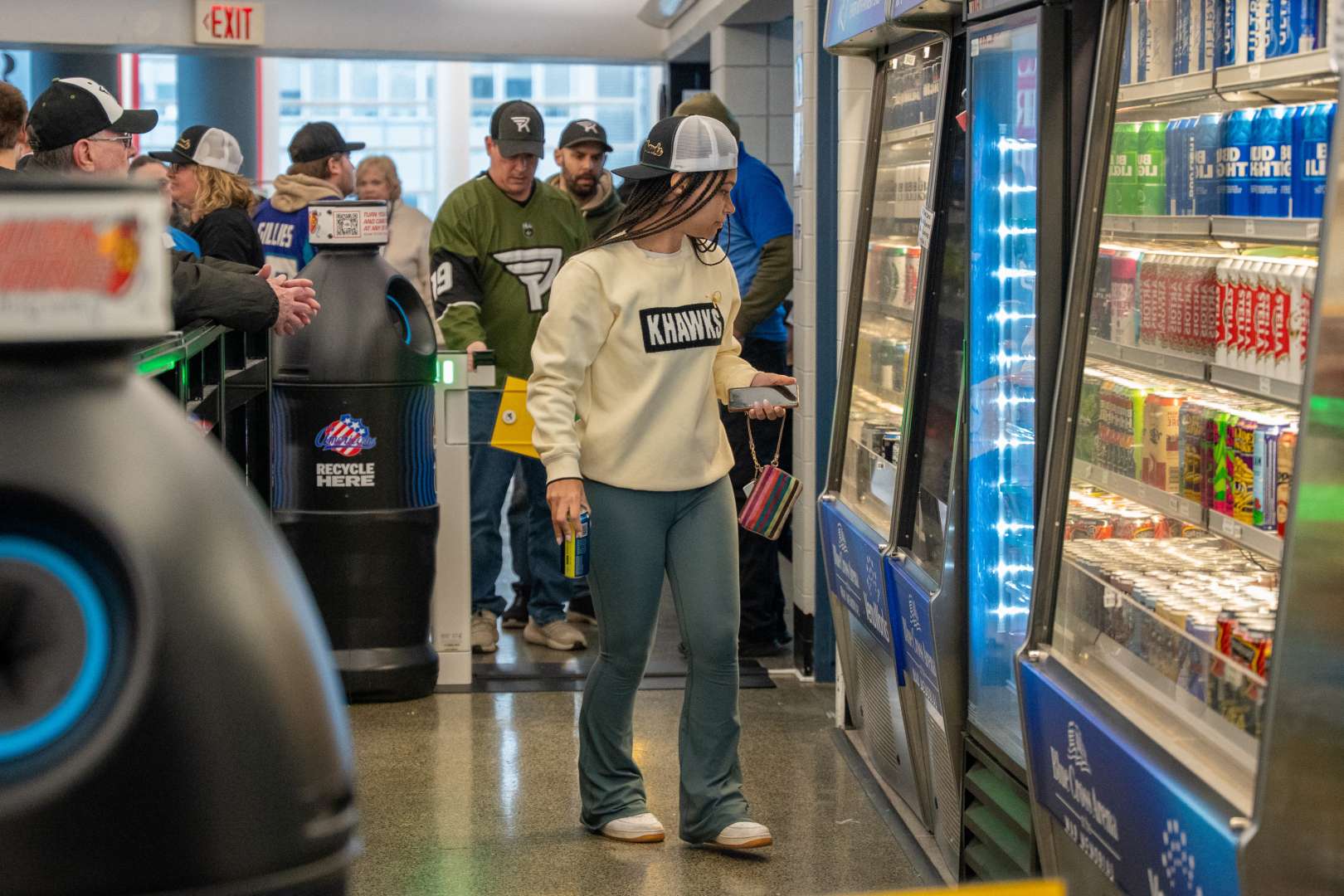 Photo of girl browsing in the Amazon Just Walk Out store in Rochester's Blue Cross Arena