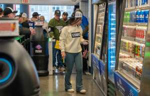 Thumbnail photo of girl browsing in the Amazon Just Walk Out store in Rochester's Blue Cross Arena