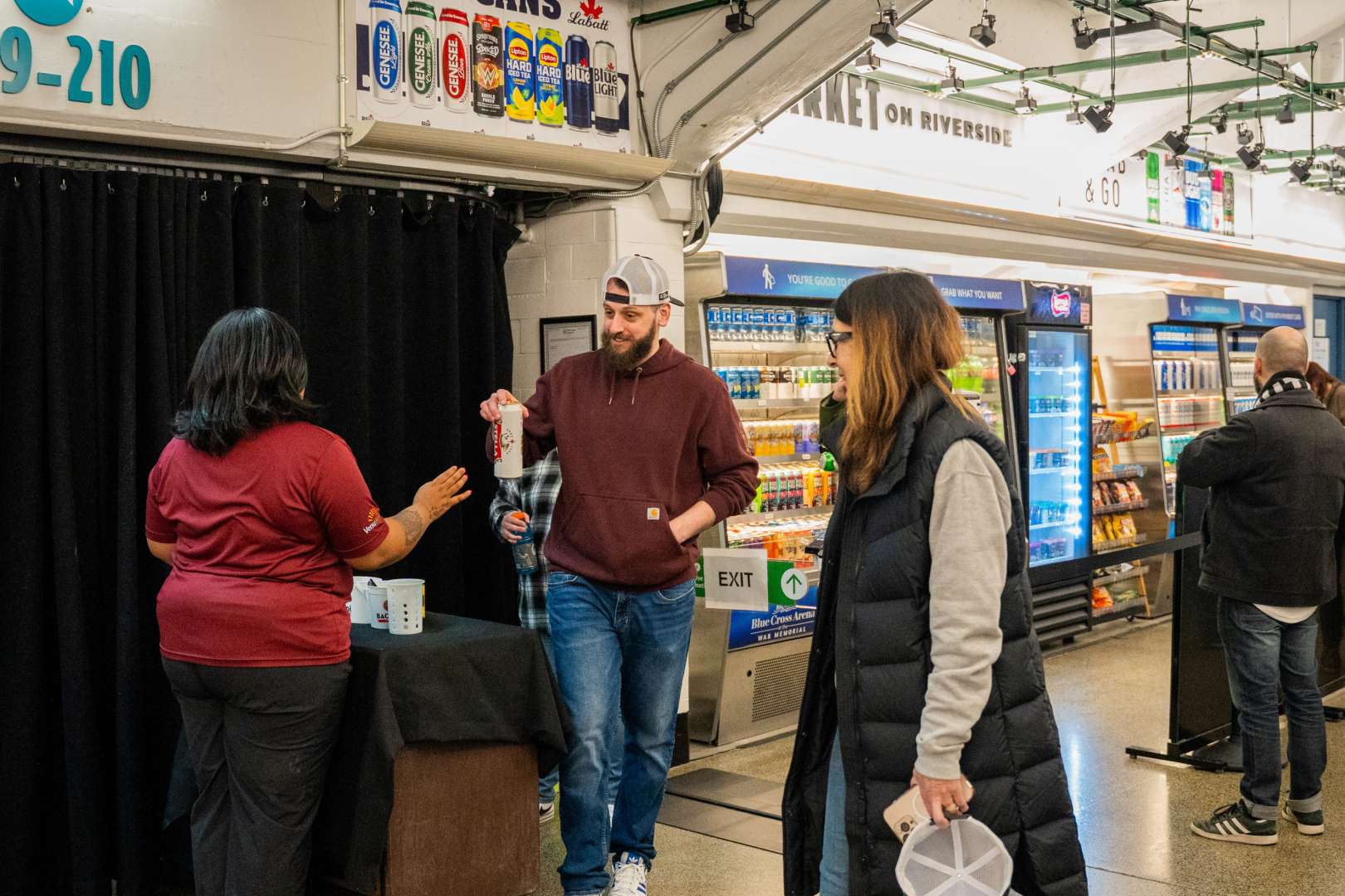 Photo of A couple shopping in the Amazon Just Walk Out store in Rochester's Blue Cross Arena