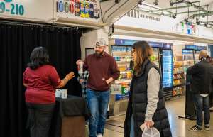 Thumbnail photo of A couple shopping in the Amazon Just Walk Out store in Rochester's Blue Cross Arena