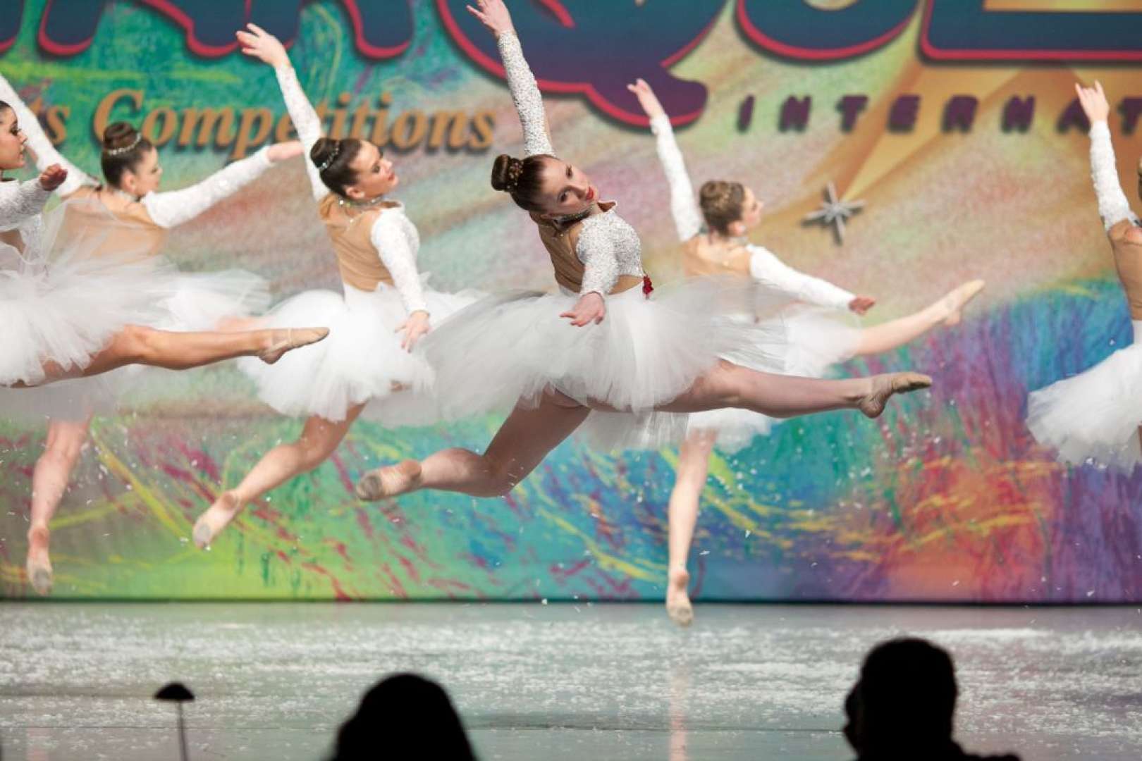 Photo of Ballerinas in tutus mid-leap