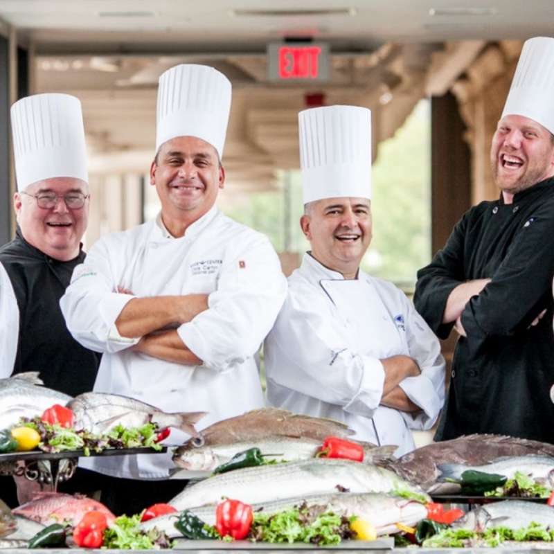 Four VenuWorks Chefs laughing