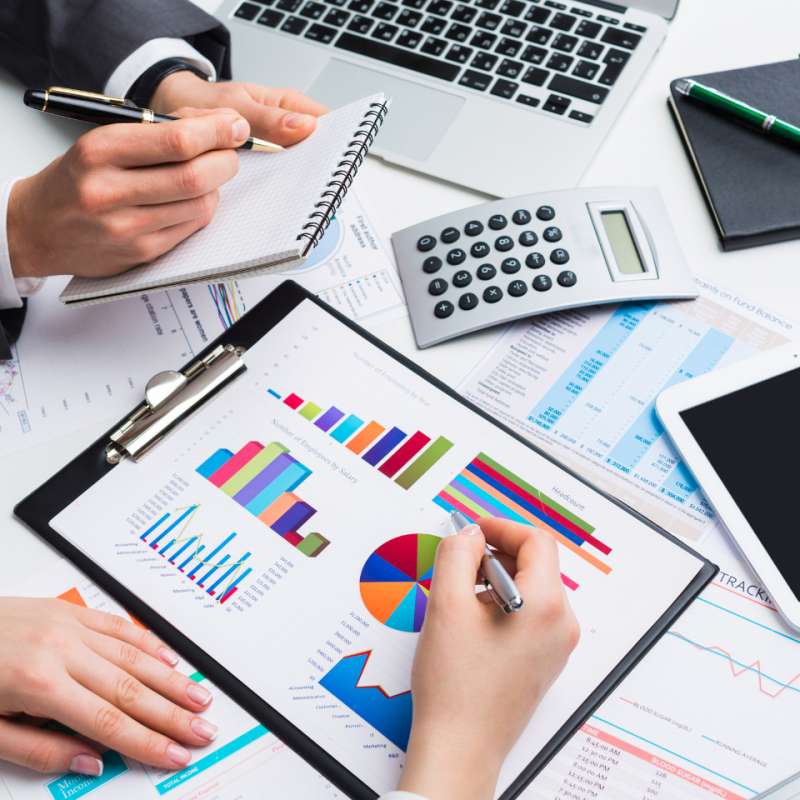 2 sets of hands reviewing reports