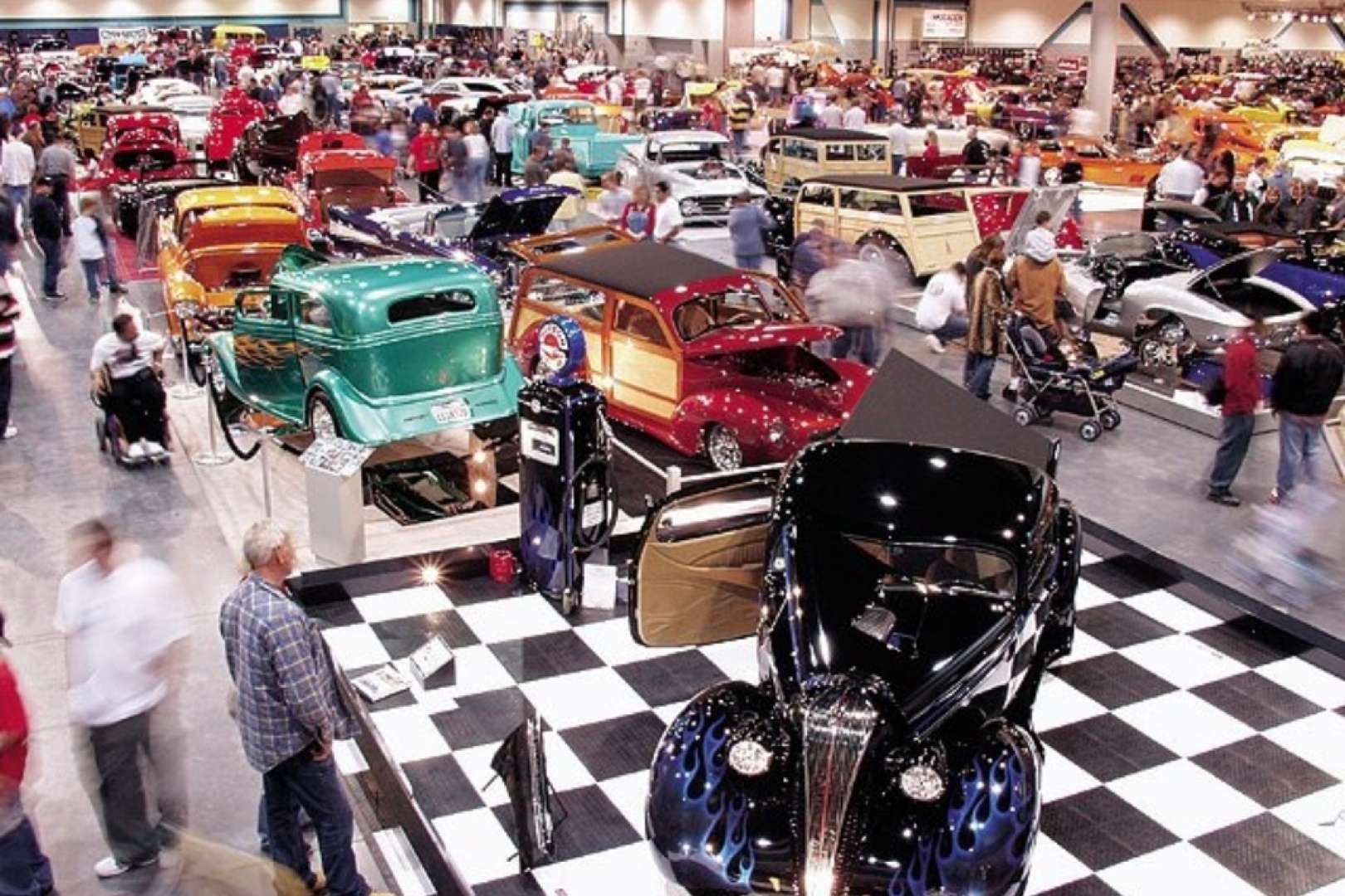 Photo of Attendees admiring cars at a car show at the Fresno Convention Center