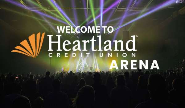 an image of a concert on stage at the Heartland Credit Union Arena with a light show POV audience