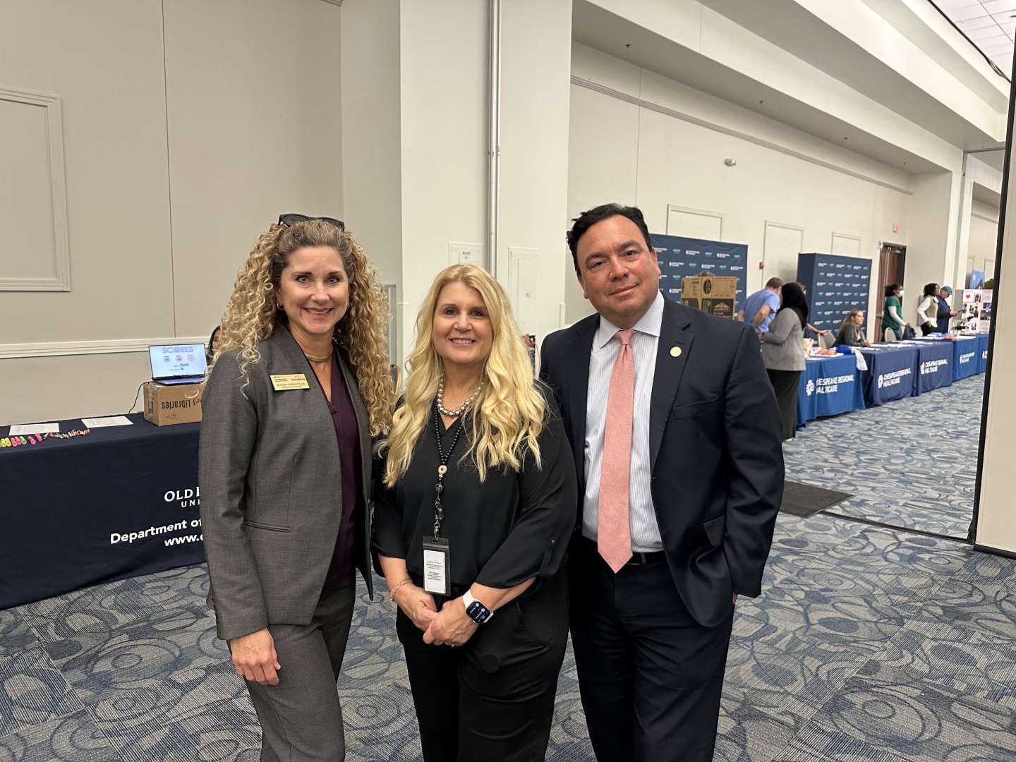 Photo of A photo of Chesapeake Conference Center Executive Director Donna Cannatella with Chesapeake Public Schools Lori Martin and Brian Martin, Chesapeake Deputy City Manager
