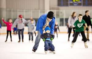 Thumbnail photo of Father helping child skate on the ImOn Ice Rink
