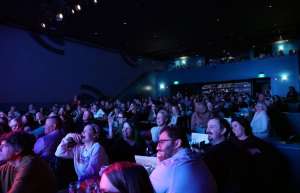Thumbnail photo of POV an audience looking to the stage of the Ingersoll and enjoying the show.