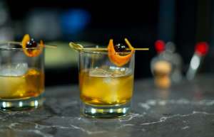 Thumbnail photo of 2 old fashioned cocktails sit on the bar at the Ingersoll