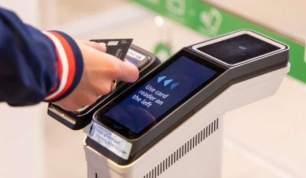 Image of person tapping a card to enter a just walk out store