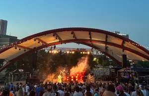 Thumbnail photo of Arial footage of the McGrath Amphitheatre at night with a concert and full house.