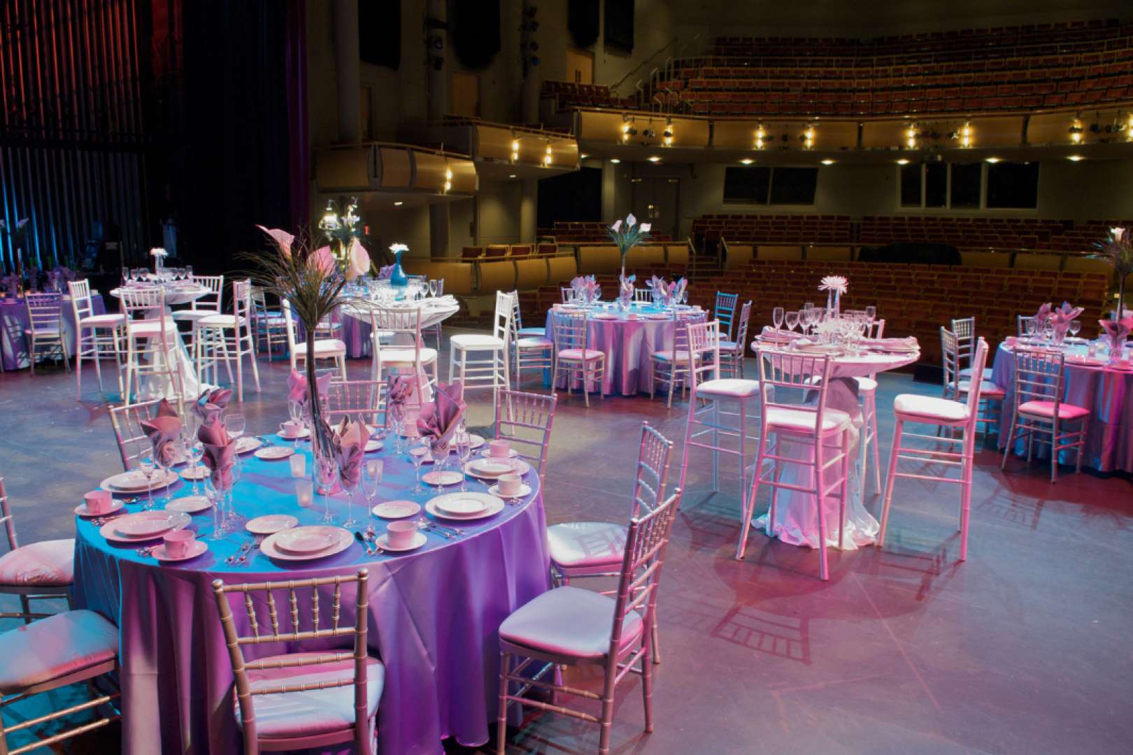 Photo of Stage of the North Shore Center for the Arts set up for a wedding banquet with round tables