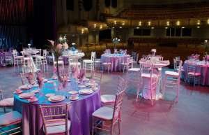 Thumbnail photo of Stage of the North Shore Center for the Arts set up for a wedding banquet with round tables
