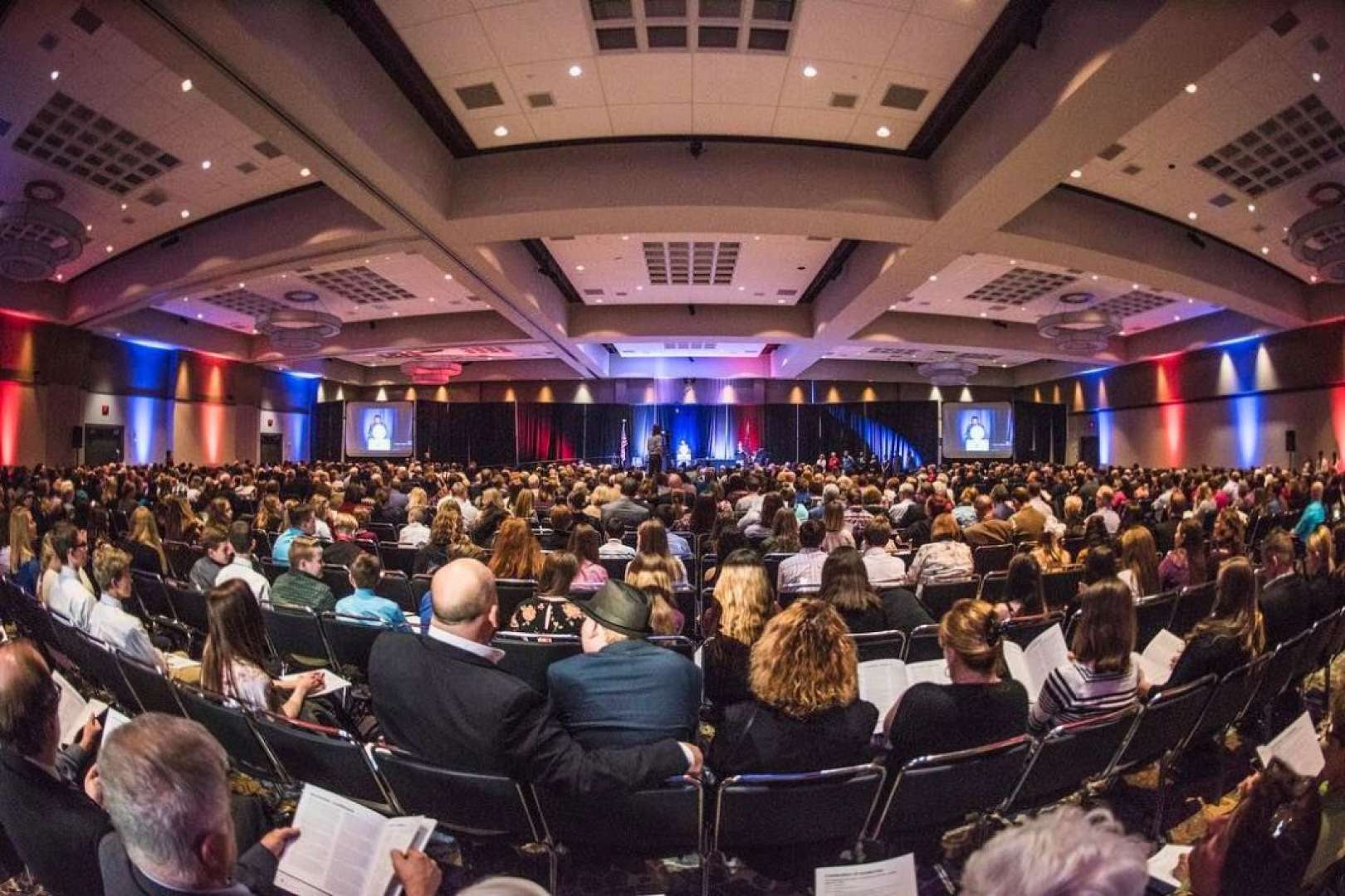 Photo of Audience watching the stage at a conference in the One National Events Plaza