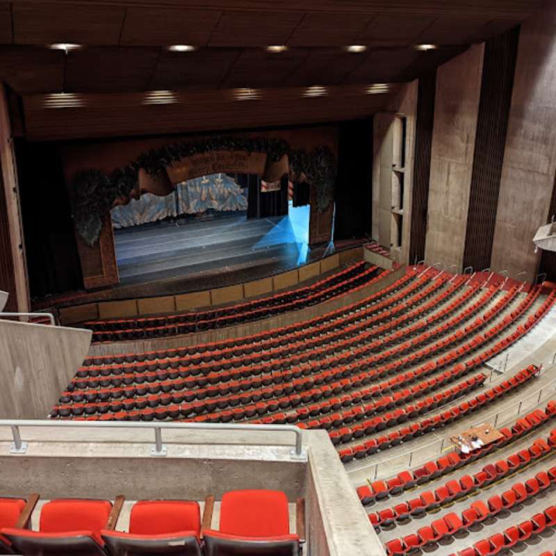 Areal view of theatre with stage and red seats