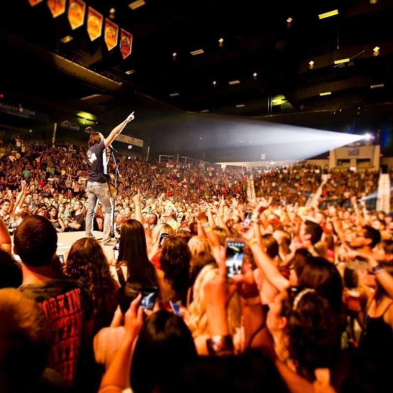 Image of singer on stage from POV of concert goer