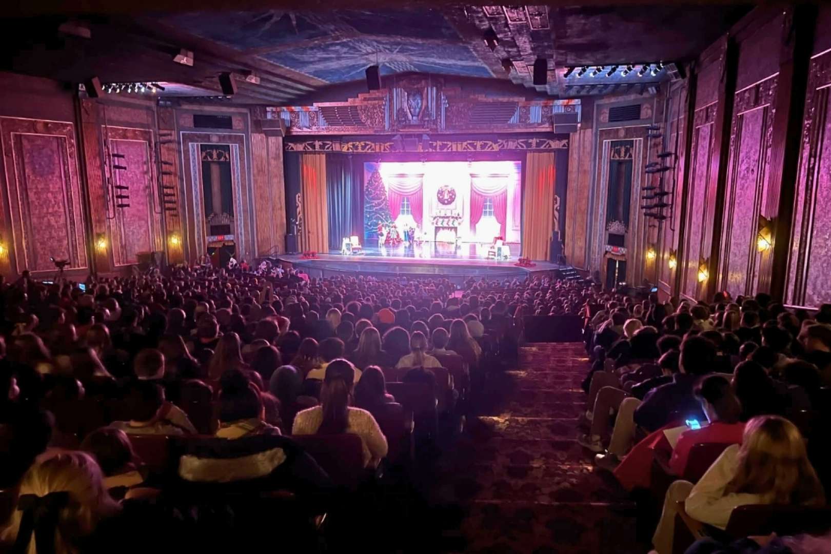 Photo of Audience members enjoying a theatrical performance on stage at the Paramount Theater of Ashland.