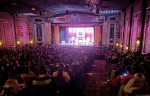Thumbnail photo of Audience members enjoying a theatrical performance on stage at the Paramount Theater of Ashland.