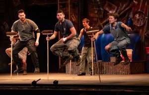 Thumbnail photo of Stomp Dancers on stage with brooms