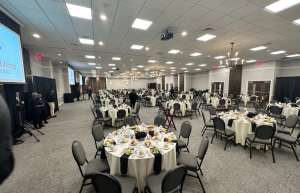Thumbnail photo of Hall set up for a wedding or gala event with table settings