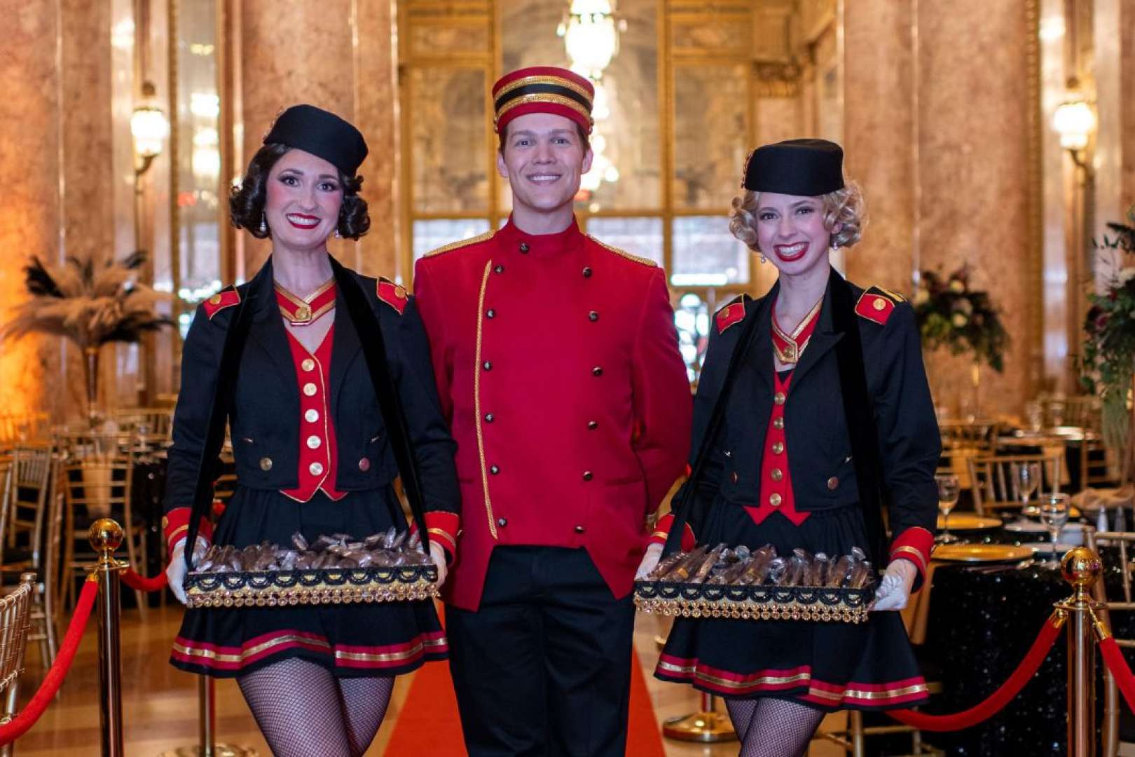 Photo of 3 actors dressed in 1920s clothes as usher and cigarette girls a the Rialto Square theatre