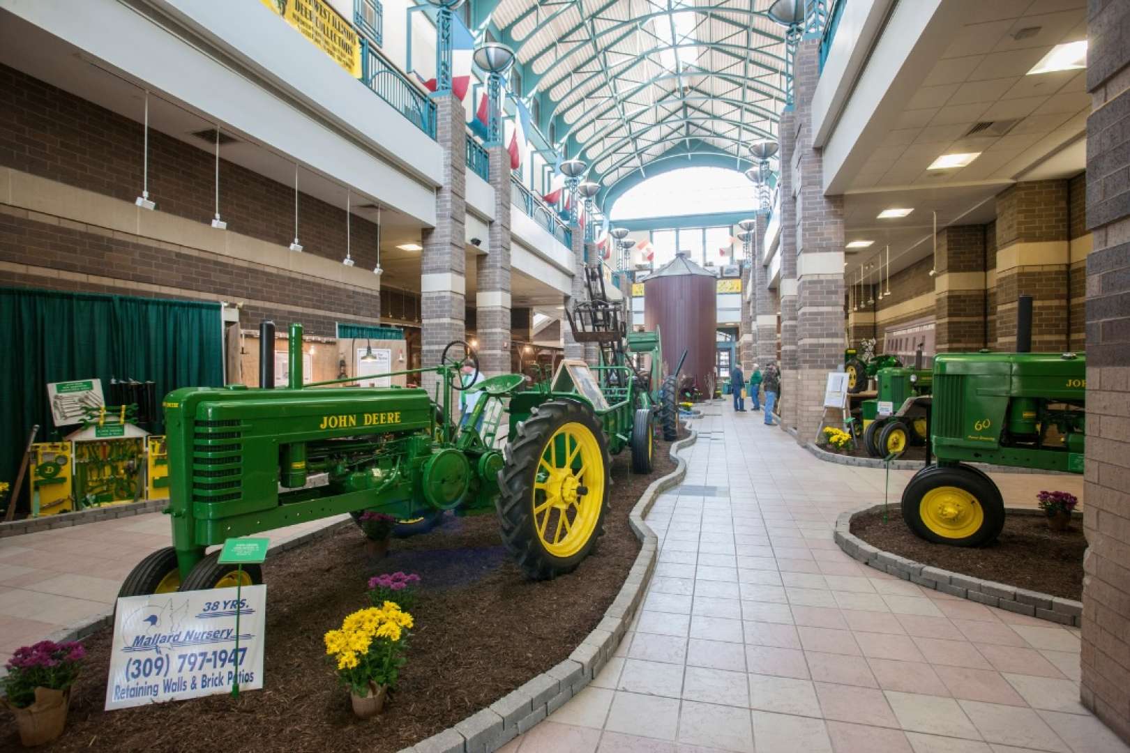 Photo of John Deere tractors on display in the lobby of the River Center