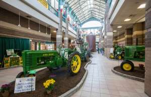 Thumbnail photo of John Deere tractors on display in the lobby of the River Center