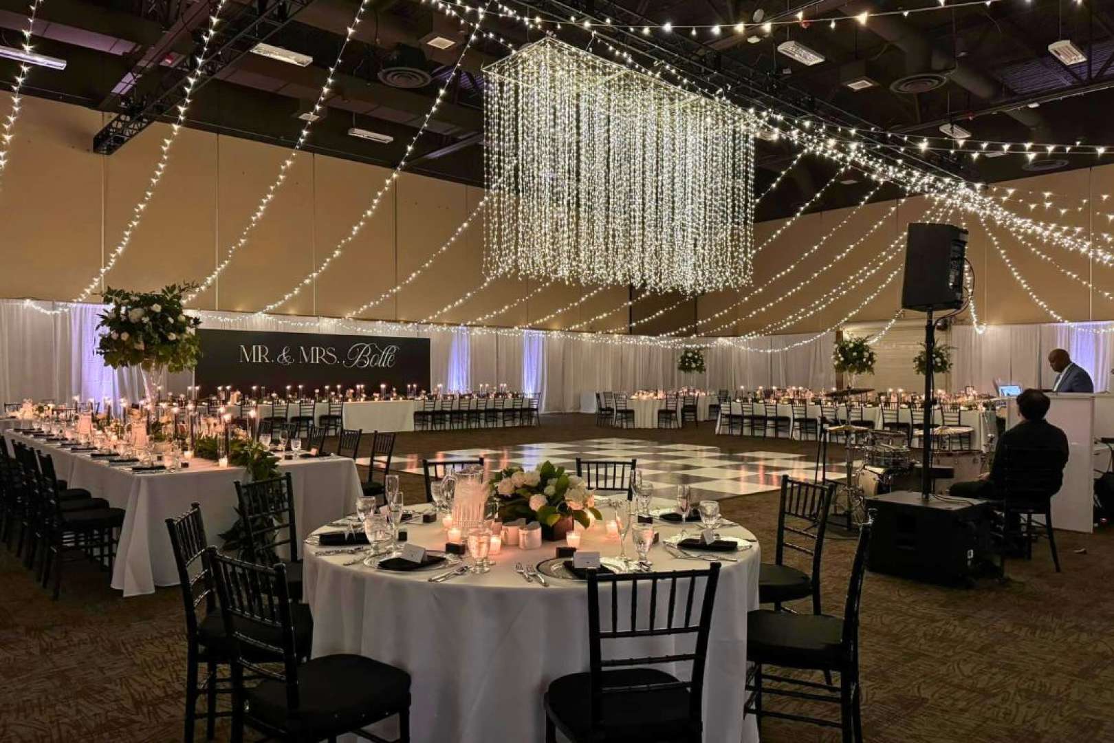 Photo of River Center main hall set up for a wedding with round tables