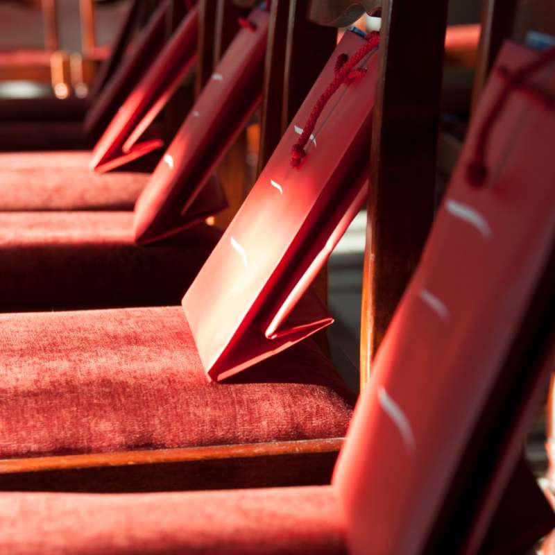 red theatre seats with a red swag bag on each