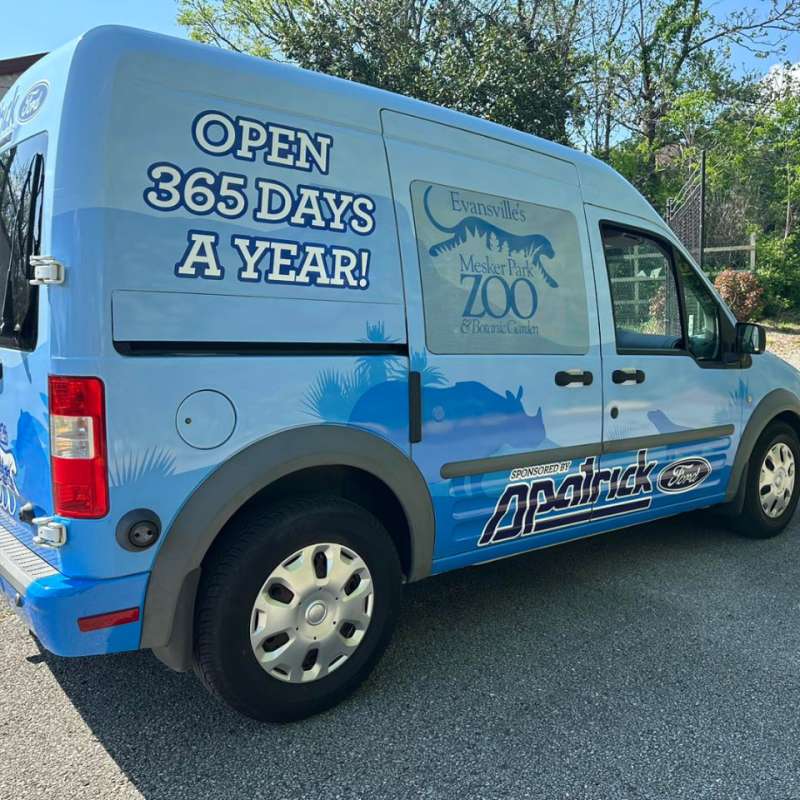 A blue van advertising the Evansville Zoo