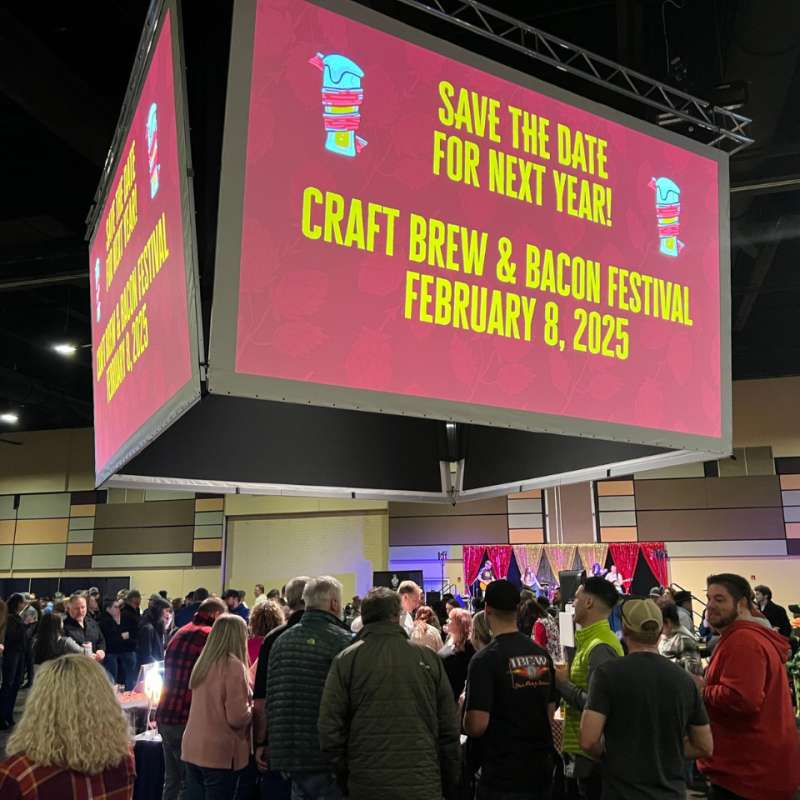 Custom VenuWorks jumbotron at event that reads