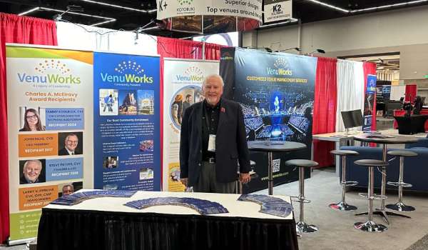 VenuWorks CEO Steve Peters on a VenuWorks booth at a trade show