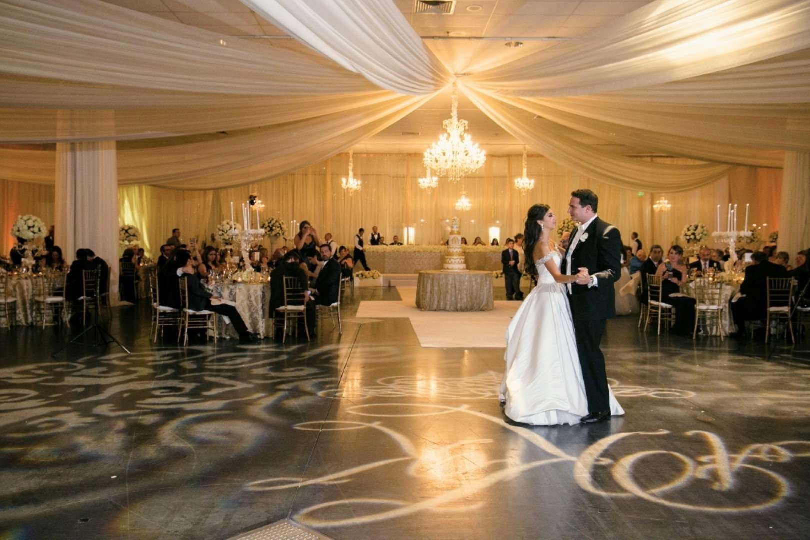 Photo of Bride and Groom celebrating their first dance at a wedding reception at the Valdez Hall