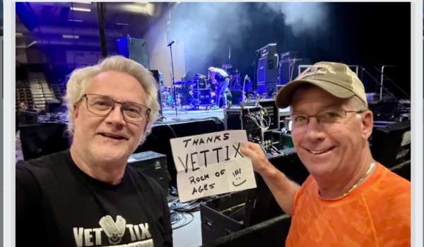 Alan, U.S. Army veteran at a Broadway Rock of Ages show in the Oshkosh Arena holding up a sign that says thank you VetTix