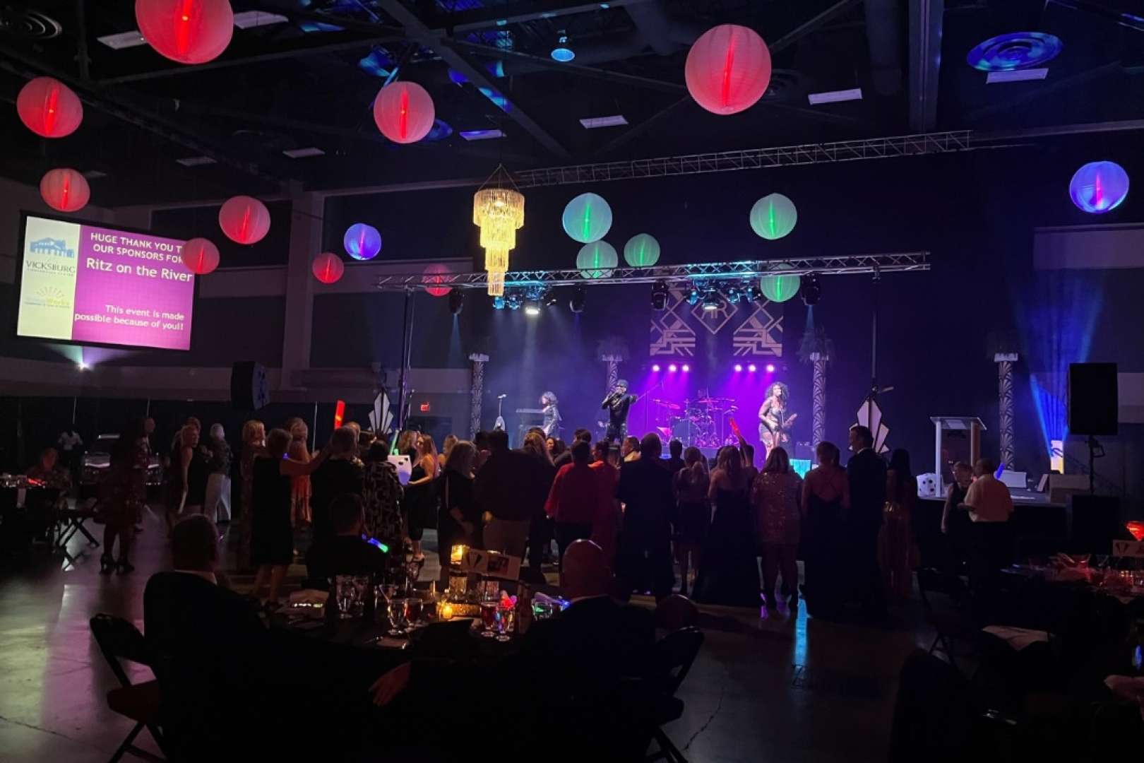 Photo of Band on stage at Vicksburg Convention center from audience POV