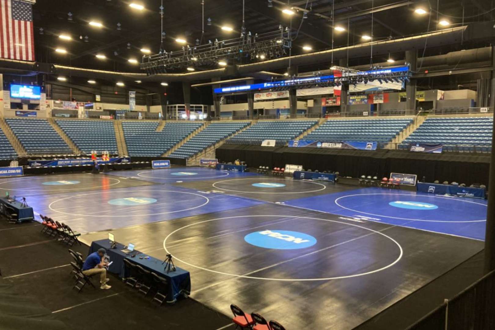 Photo of A venue preparing for a wrestling competition, with the floor set up
