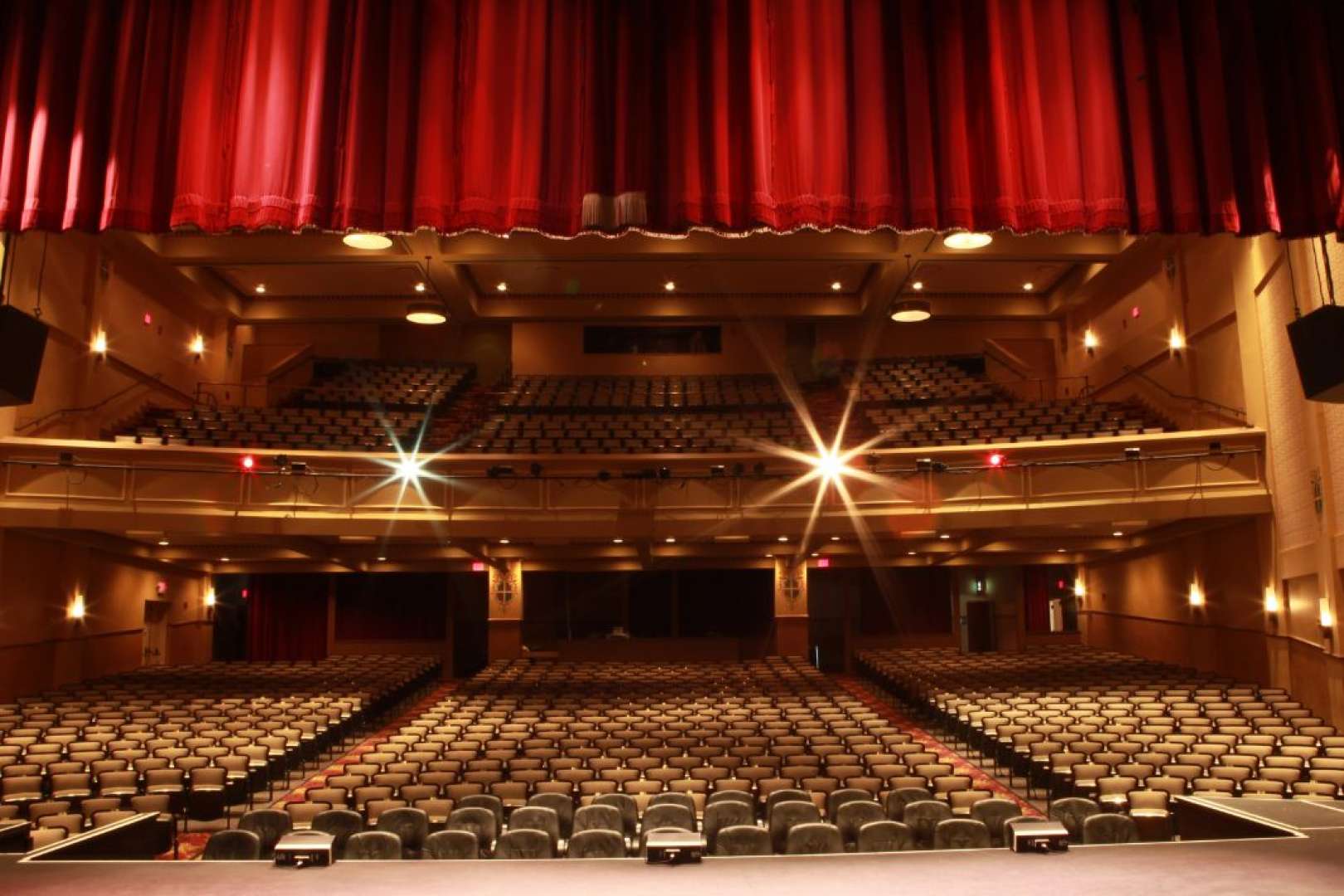 Photo of The Sunrise Theatre taken from the Stage looking towards the House, empty and lit.